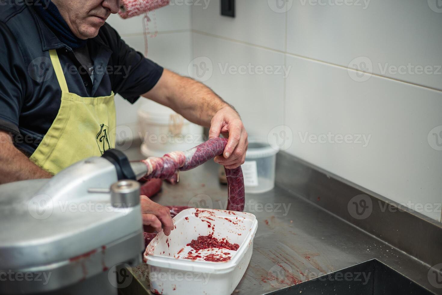 copyspace Closeup of Cook Stuffing Long Sausage with Meat Using Machine photo