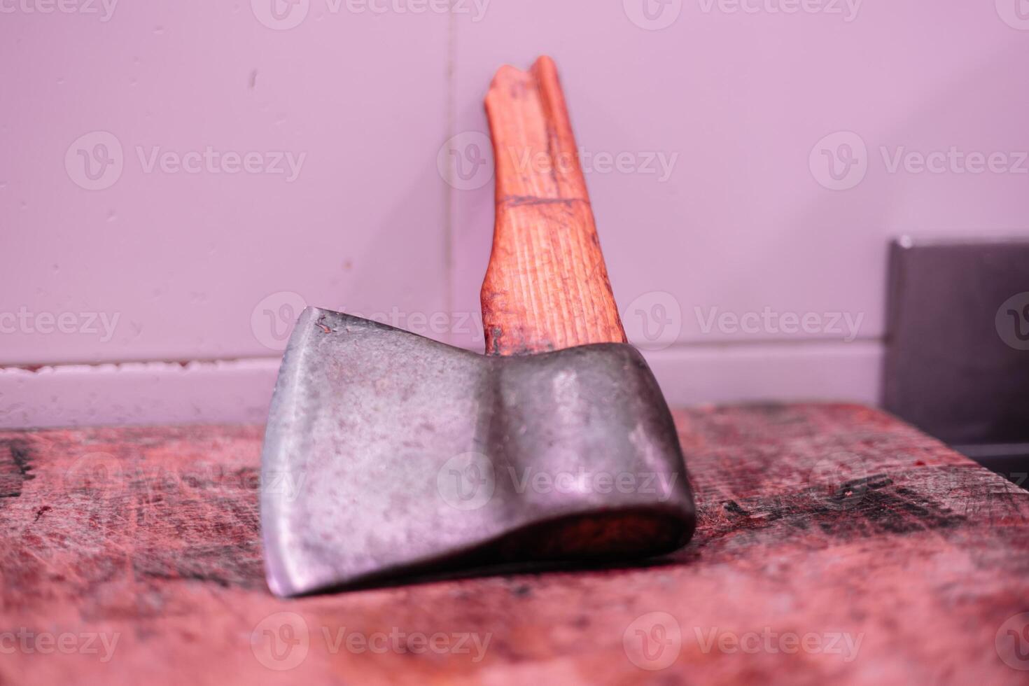 Closeup of Broken-Handled Butcher's axe Cleaver on Meat Cutting Board photo