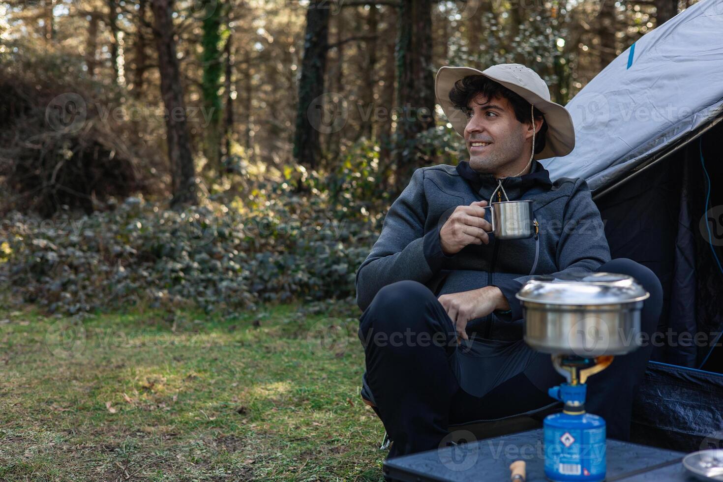 copyspace Serene Camper Enjoying Coffee Amidst Nature's Embrace photo