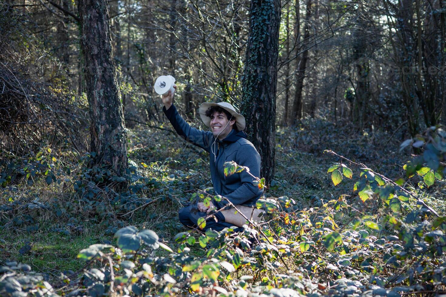Explorer Practicing Wilderness Hygiene Behind Bushes photo