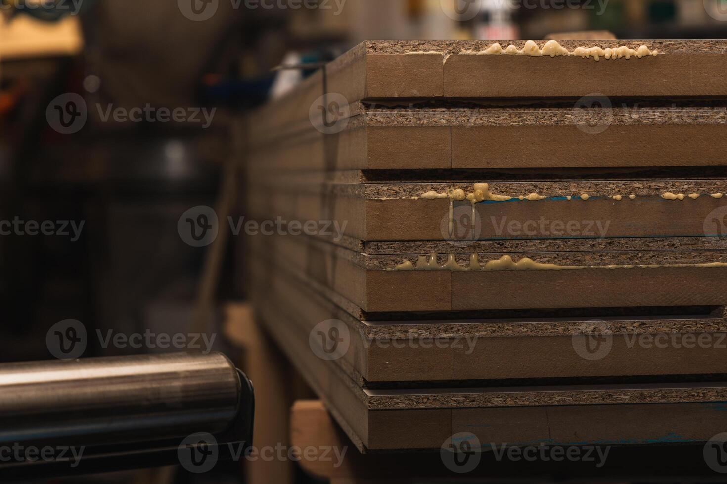 Closeup Wooden Planks Drying with Excess Glue in Carpentry Workshop photo