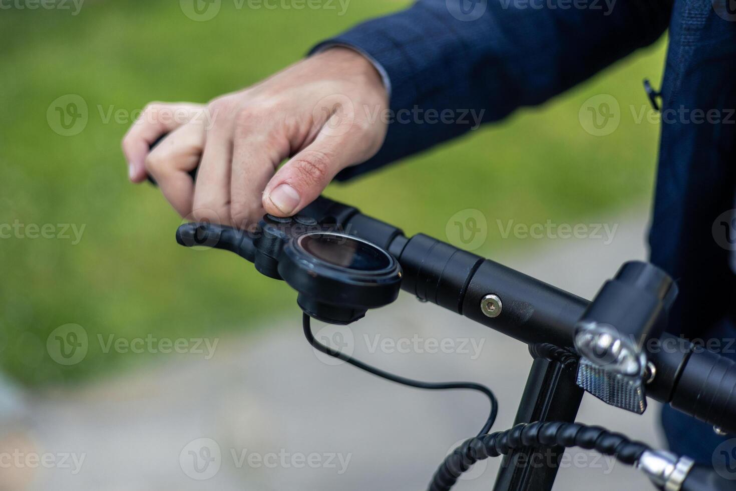 closeup Eco-Friendly Commute Close-Up of Businessman's Hand on Electric Scooter Handlebar photo