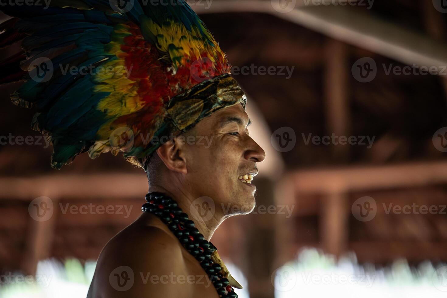 Closeup of Wayuri indigenous tribe member with feather crown in Ecuadorian jungle photo