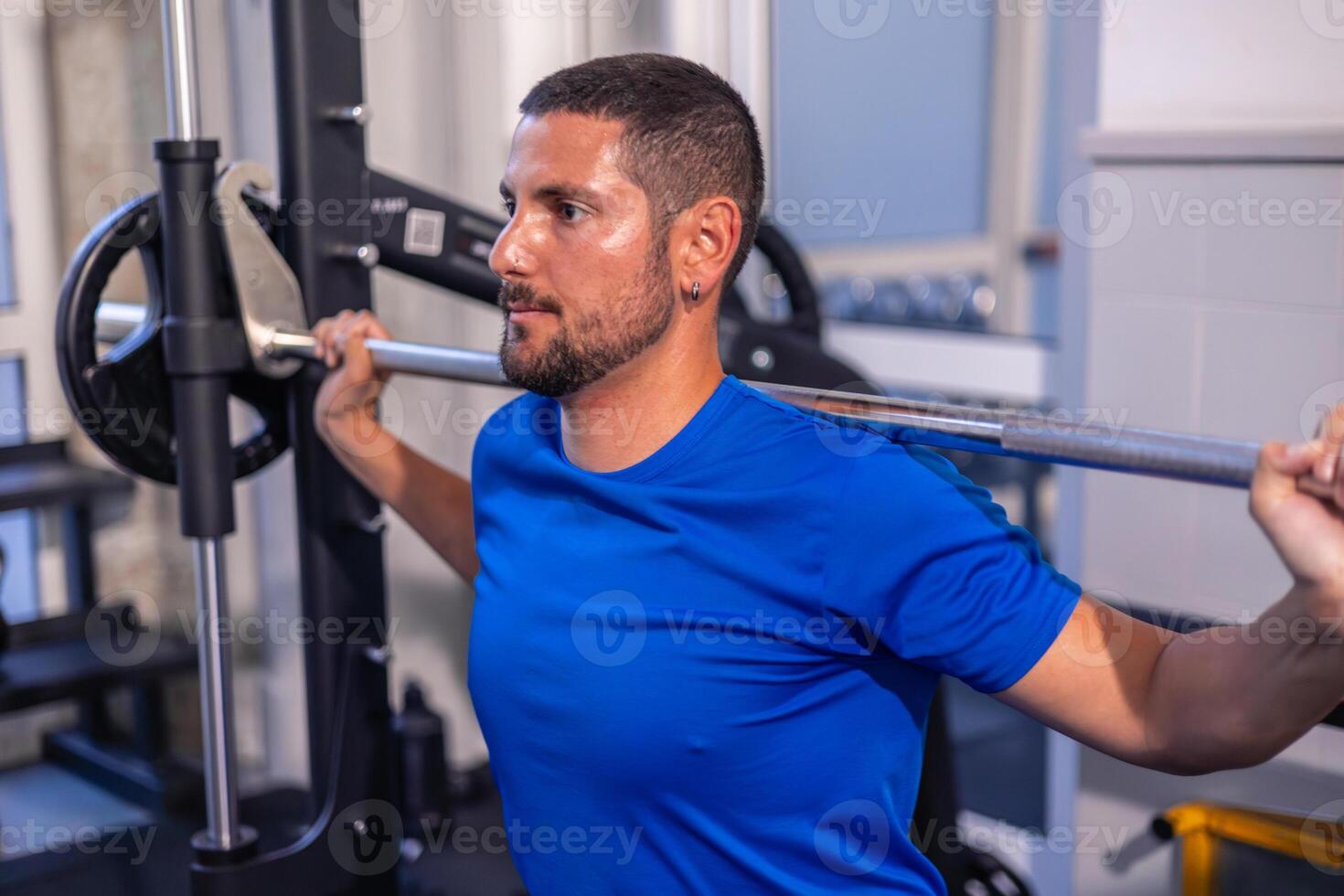 closeup Young Athlete Straining During Barbell Squats at Gym Workout photo
