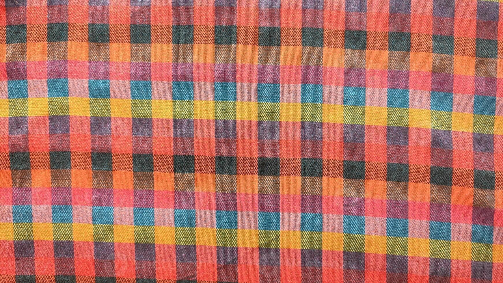 A colorful checkered fabric with a red and yellow square photo