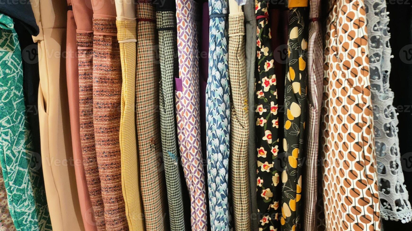 A row of clothes with different patterns and colors photo