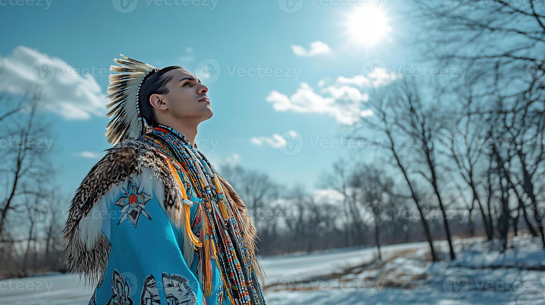 Powerful portrait of Native American man in traditional attire against winter landscape photo