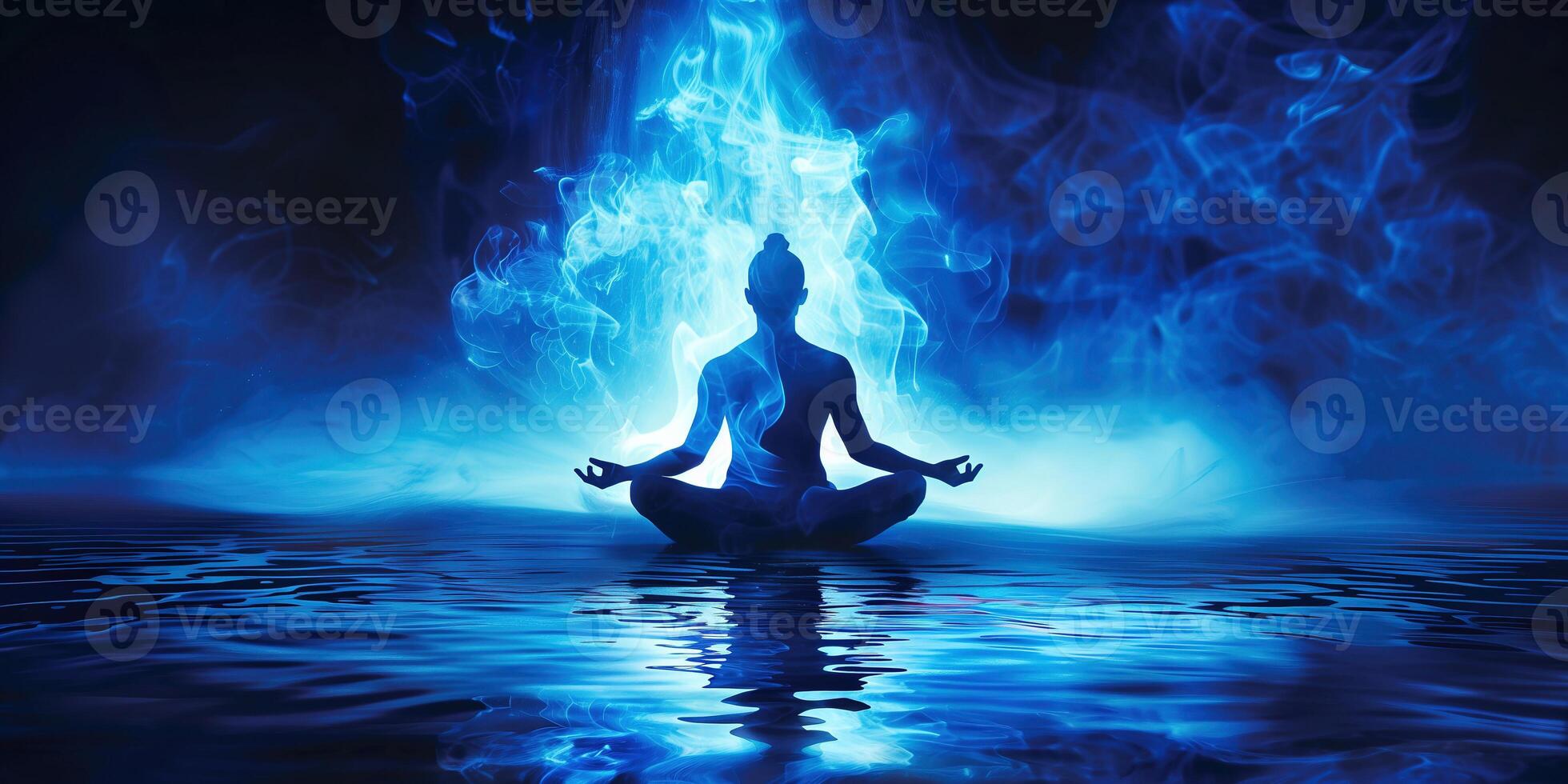 Meditation under the blue light creates a serene atmosphere on calm waters photo