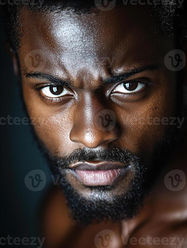 Portrait of a man with a striking expression in traditional attire against a dark background photo