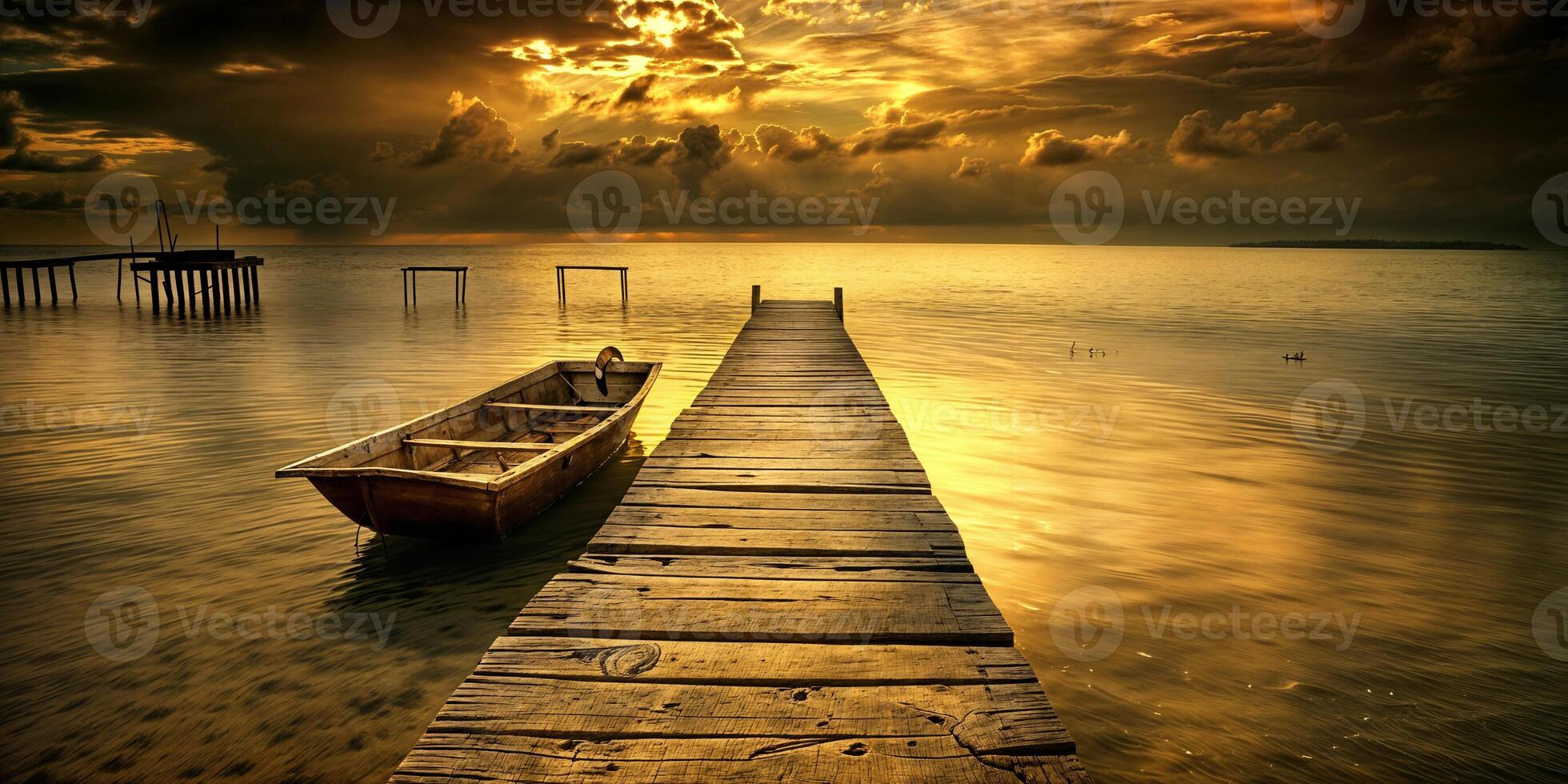 Golden sunset over tranquil waters with a wooden pier and boat in the foreground photo
