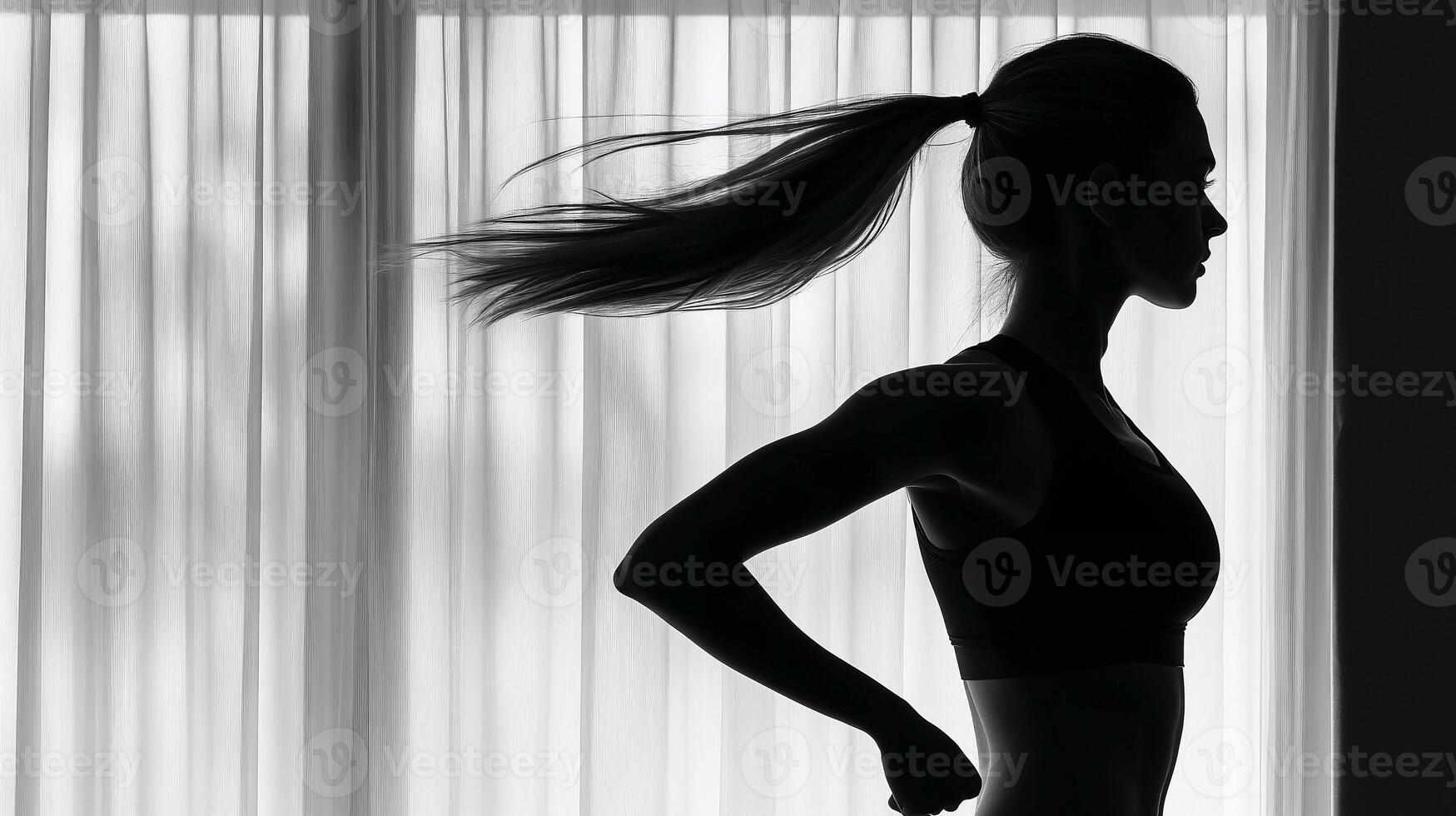 A strong woman figure in silhouette prepares for a run, showcasing dedication to a healthy lifestyle photo