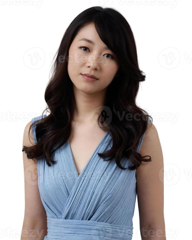 A woman with long, dark hair, wearing a blue dress, poses against a light background, showcasing her soft, serene expression. on white background photo