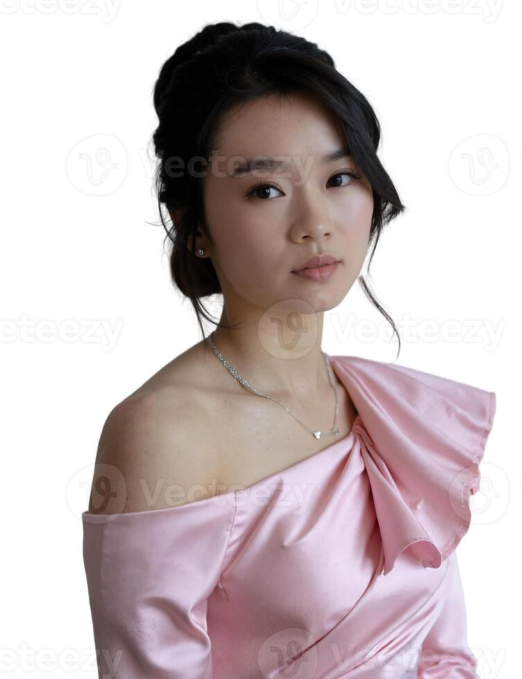 A photograph of a young Asian woman with a delicate face, wearing a pink off-shoulder dress, styled in a natural setting. photo