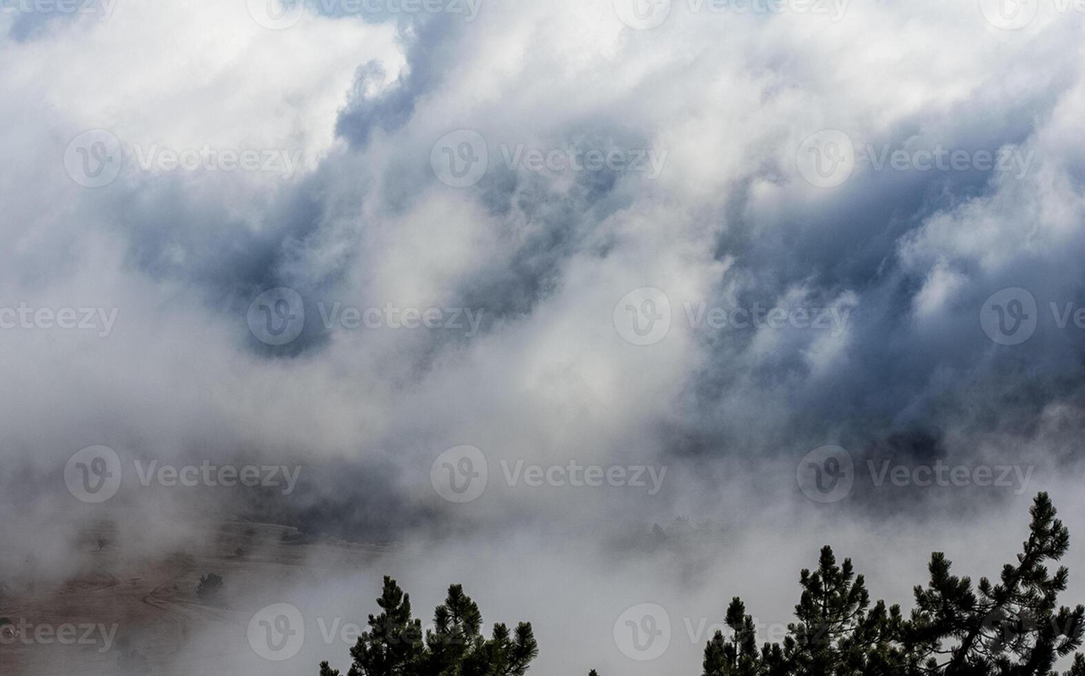 Low clouds over valley, view from the mountains. Low clouds. photo