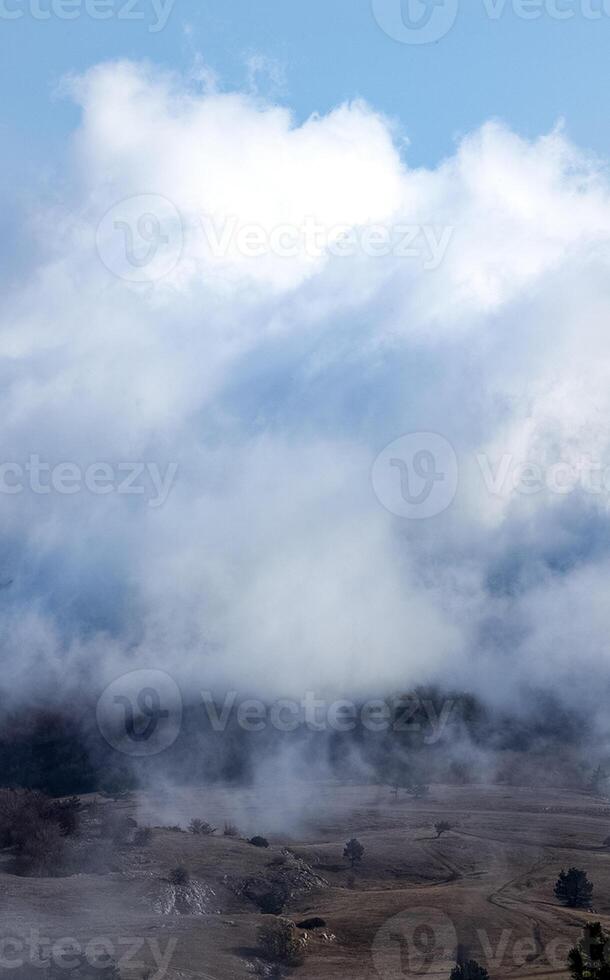 Low clouds over valley, view from the mountains. Low clouds. photo