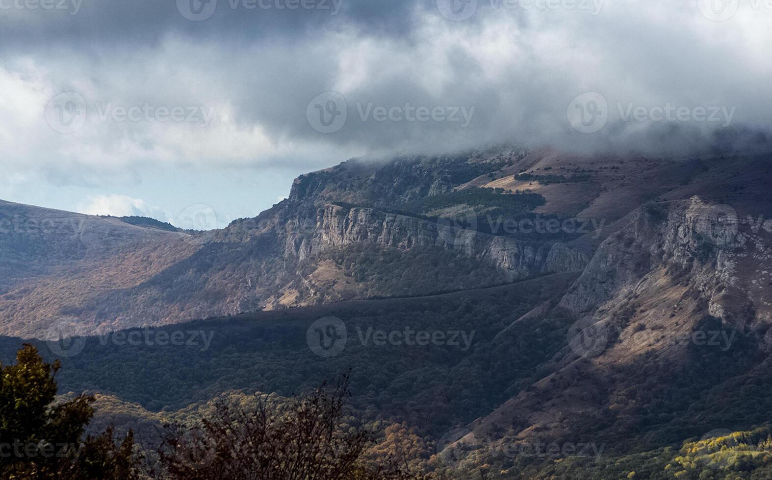 Mountains and forests of Crimea. coniferous and deciduous trees on the hills of mountains and rocks photo