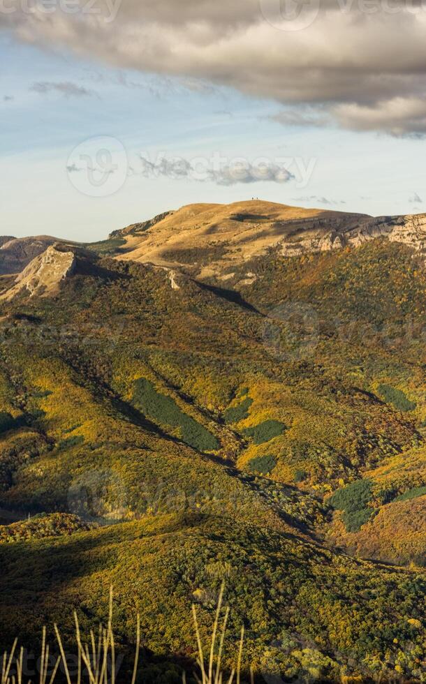 Mountains and forests of Crimea. coniferous and deciduous trees on the hills of mountains and rocks photo