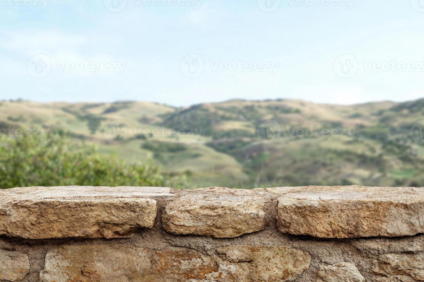 A stone wall with a view of the mountains photo