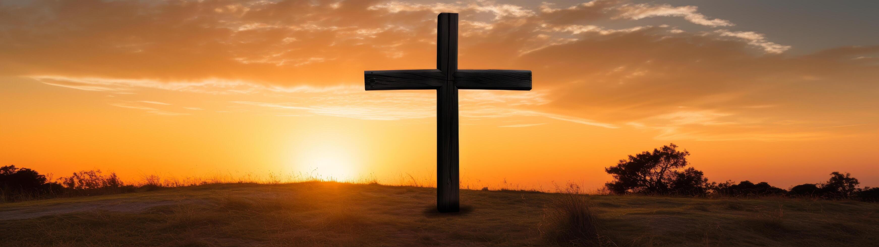 Silhouette of cross at sunset photo