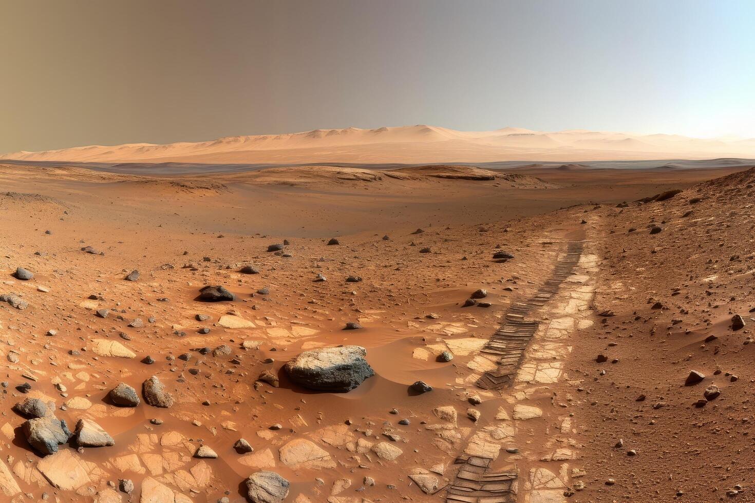 Vast desert landscape with rocky terrain and sandy path photo