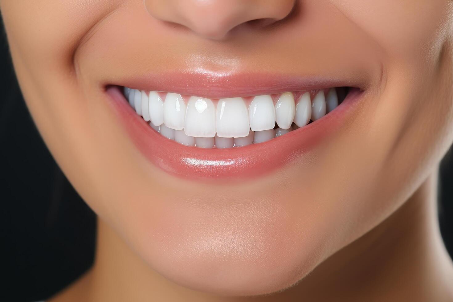 close up of a womans smiling face with perfect white teeth photo