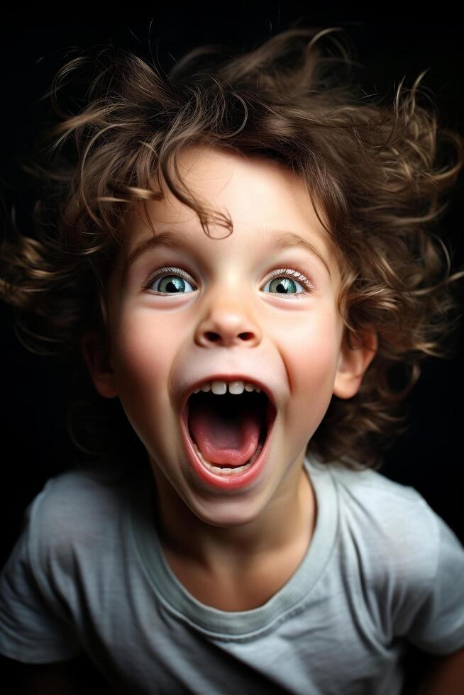 Excited young boy with curly hair photo