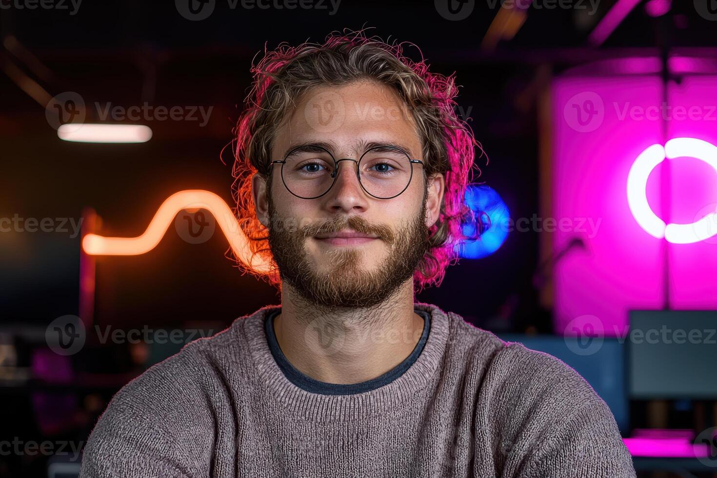 Portrait of a young man with glasses in a modern office photo