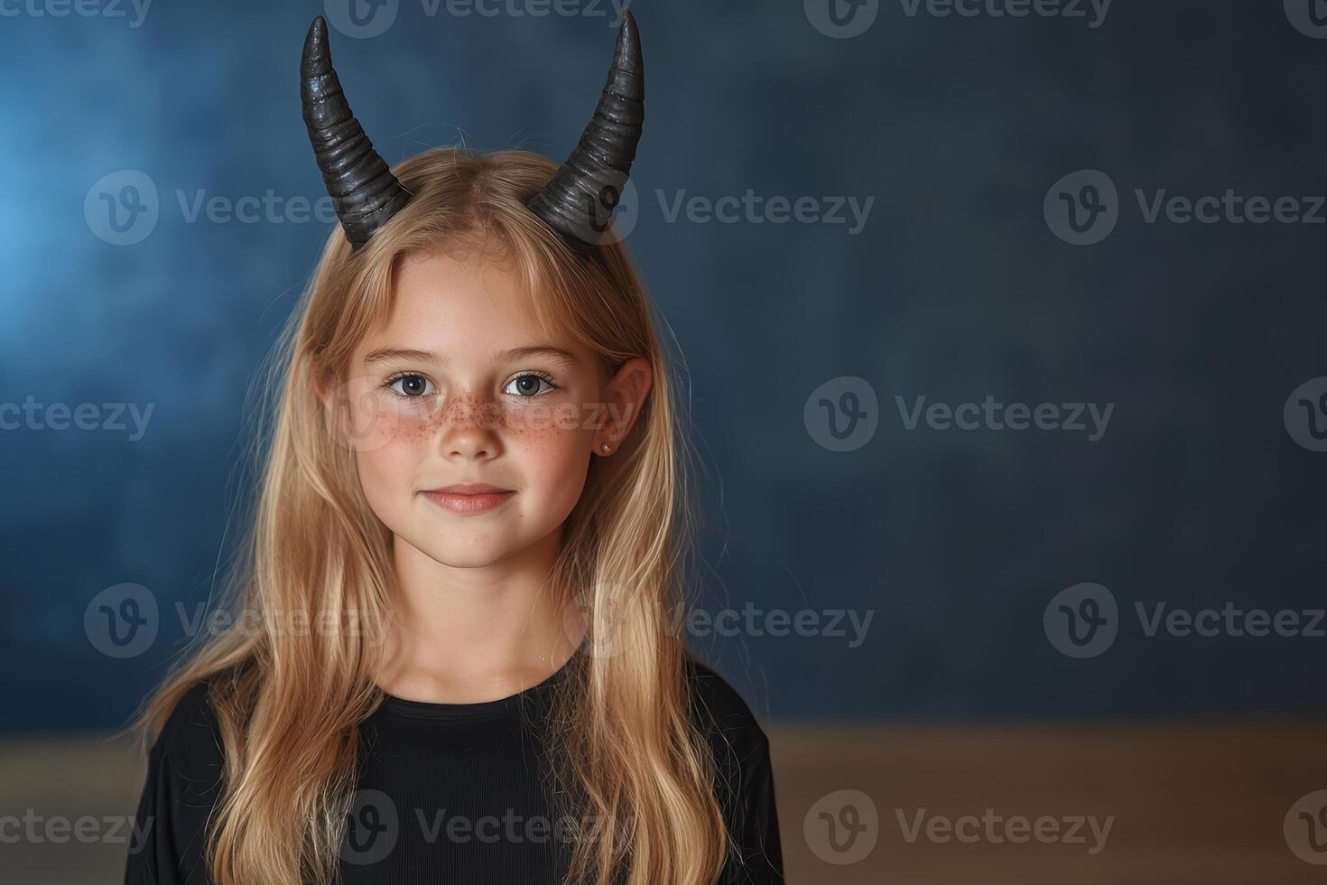 Cute girl in devil horns for Halloween photo