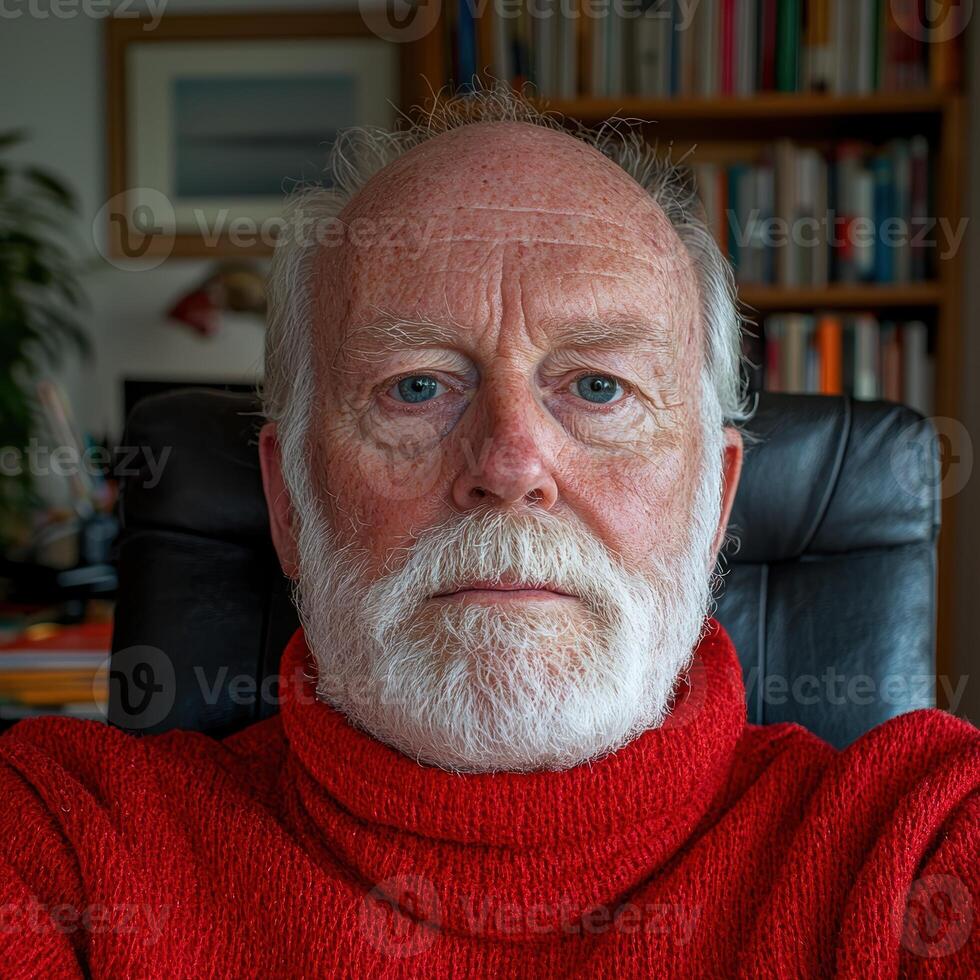 Portrait of a senior man with a white beard wearing a red turtleneck sweater photo