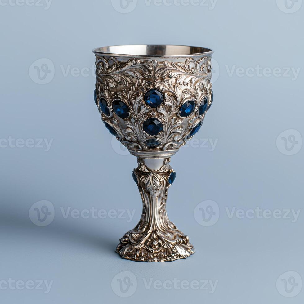 Ornate silver goblet with blue gems photo
