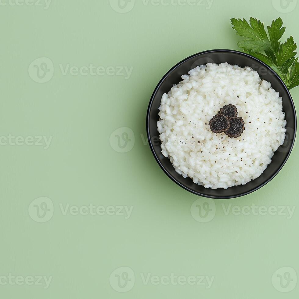 Creamy risotto with black truffle in a black bowl photo