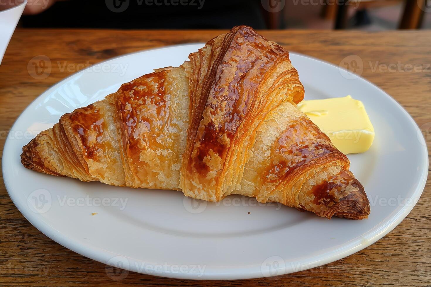 Buttery croissant on a white plate photo