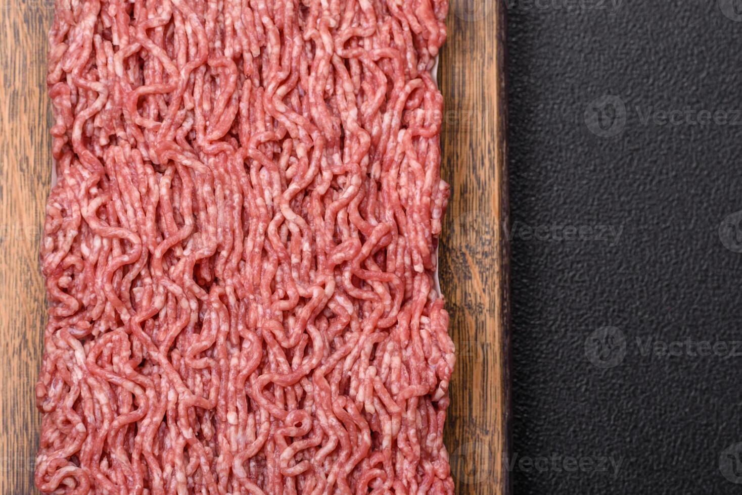 Fresh raw ground minced beef with salt and spices photo