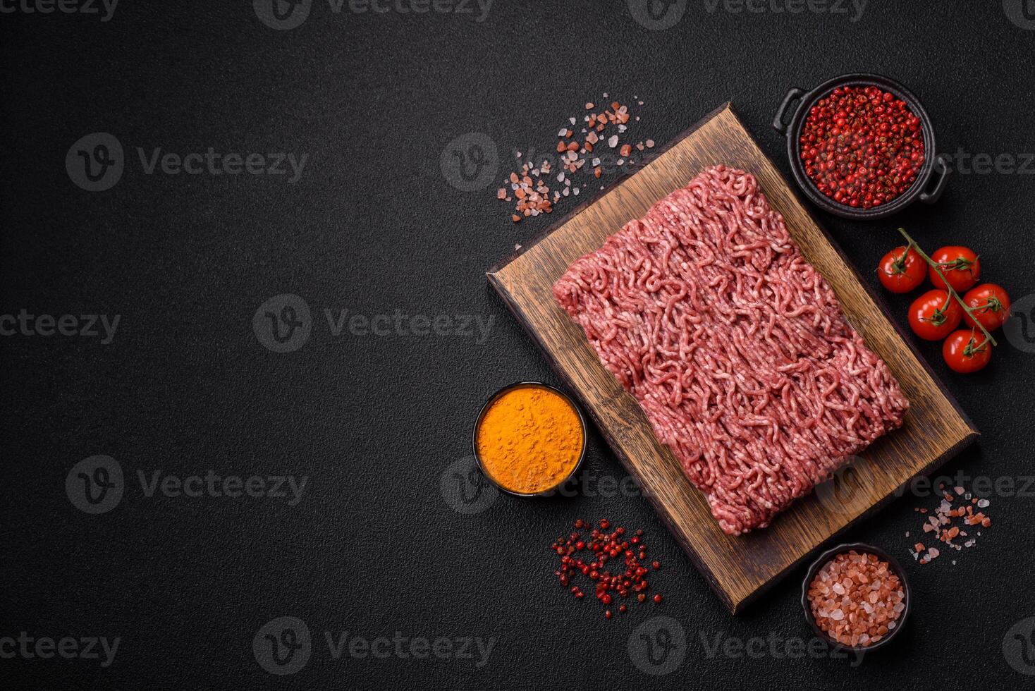 Fresh raw ground minced beef with salt and spices photo
