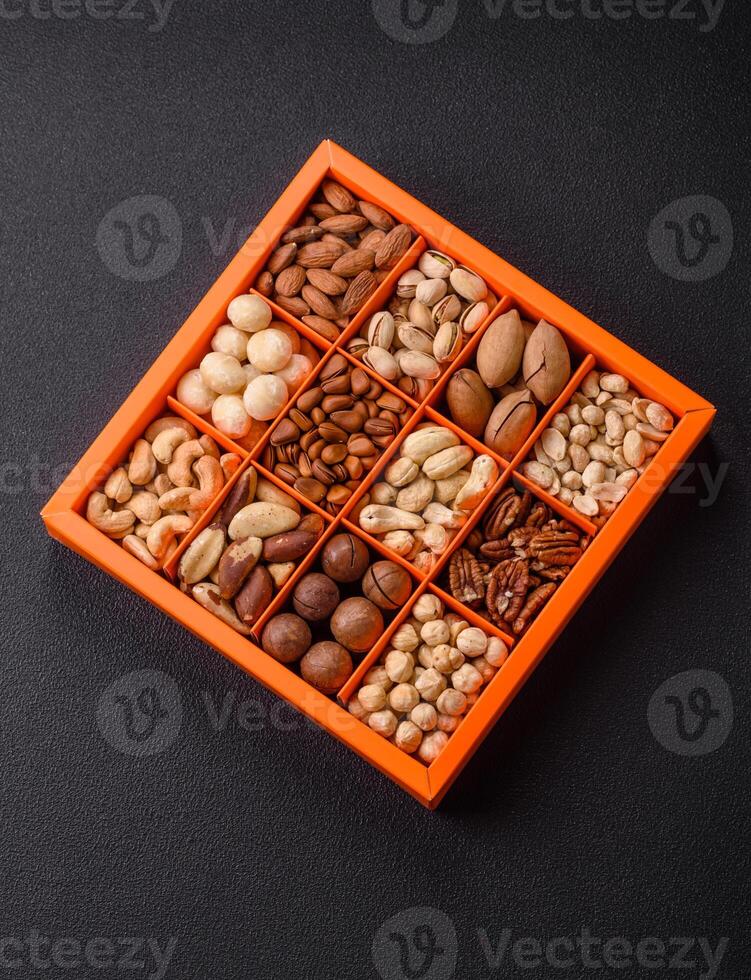 Box with various nuts cashew, macadamia, peanut, cedar, pecan, walnut, brazil, hazelnut photo