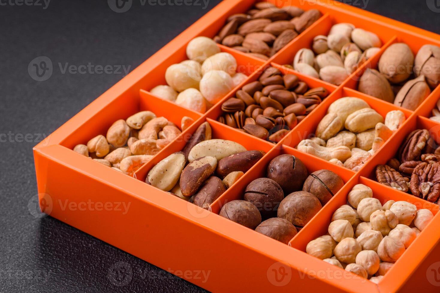 Box with various nuts cashew, macadamia, peanut, cedar, pecan, walnut, brazil, hazelnut photo