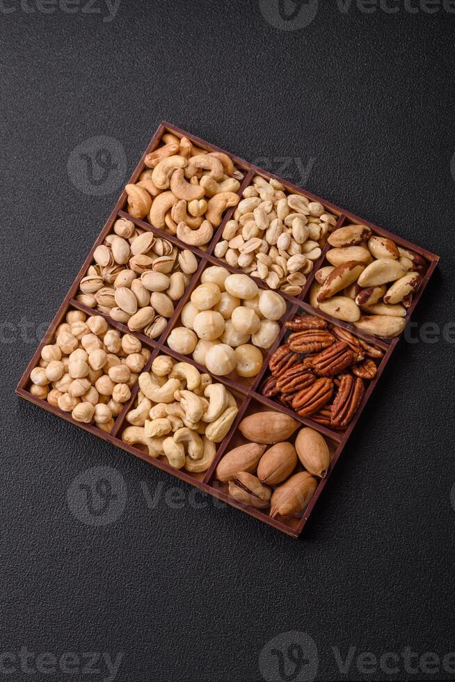 Box with various nuts cashew, macadamia, peanut, cedar, pecan, walnut, brazil, hazelnut photo