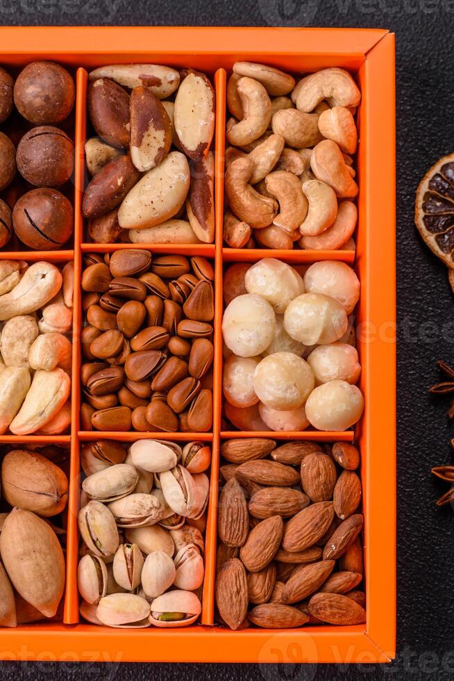 Box with various nuts cashew, macadamia, peanut, cedar, pecan, walnut, brazil, hazelnut photo