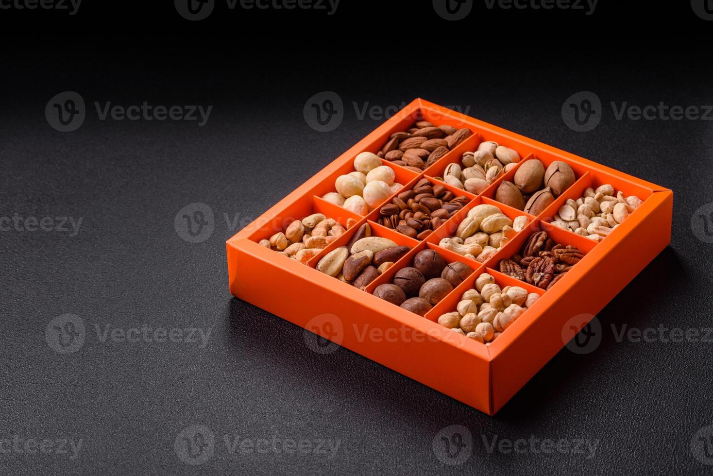 Box with various nuts cashew, macadamia, peanut, cedar, pecan, walnut, brazil, hazelnut photo