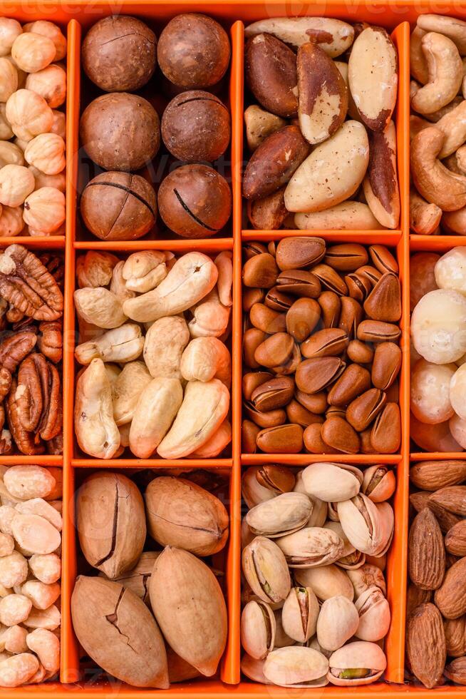 Box with various nuts cashew, macadamia, peanut, cedar, pecan, walnut, brazil, hazelnut photo