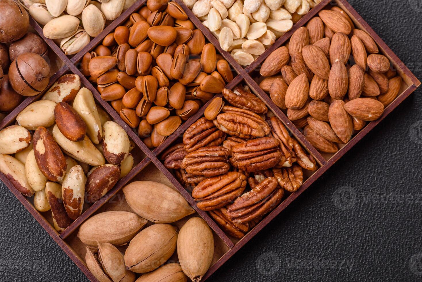 Box with various nuts cashew, macadamia, peanut, cedar, pecan, walnut, brazil, hazelnut photo
