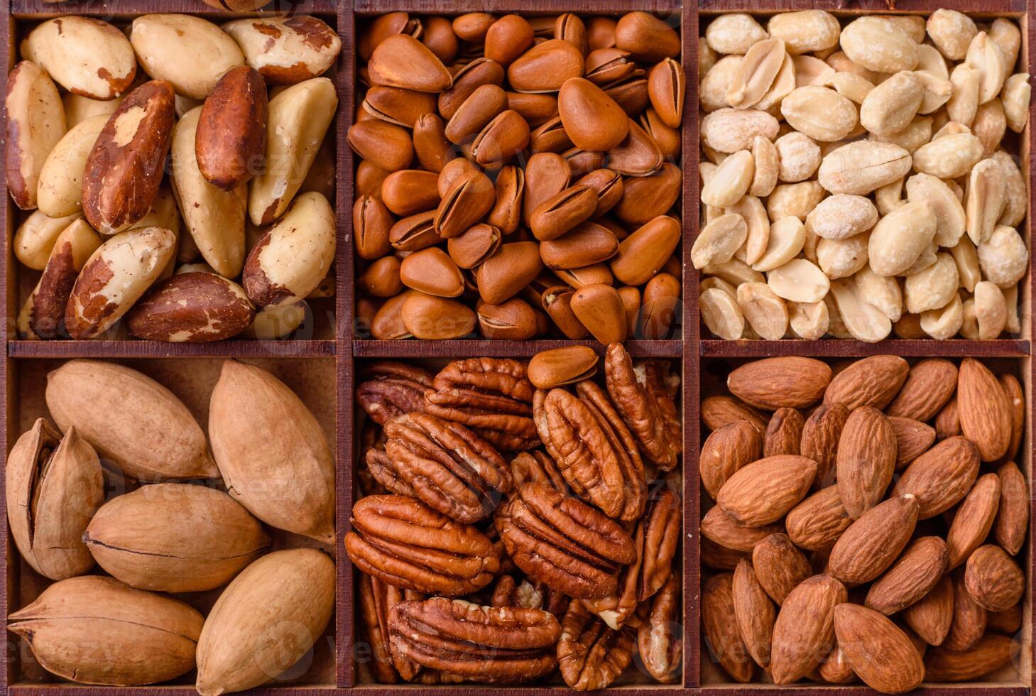 Box with various nuts cashew, macadamia, peanut, cedar, pecan, walnut, brazil, hazelnut photo