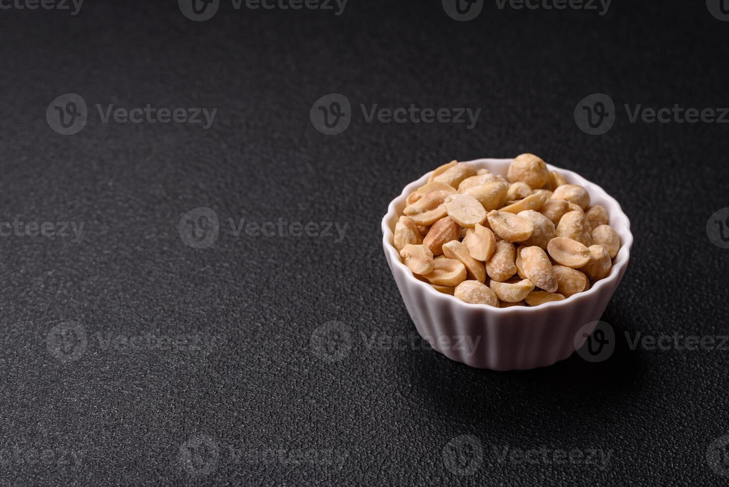 Delicious nutritious peanut in ceramic bowl photo