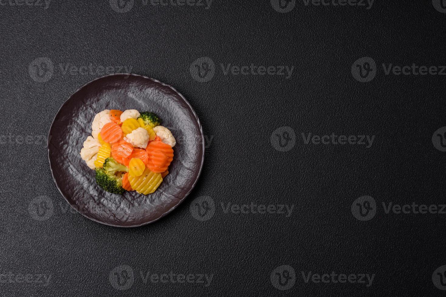 Delicious fresh vegetables steamed carrots, broccoli, cauliflower photo