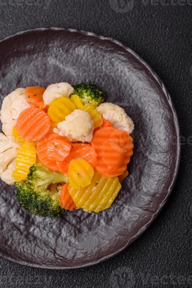Delicious fresh vegetables steamed carrots, broccoli, cauliflower photo
