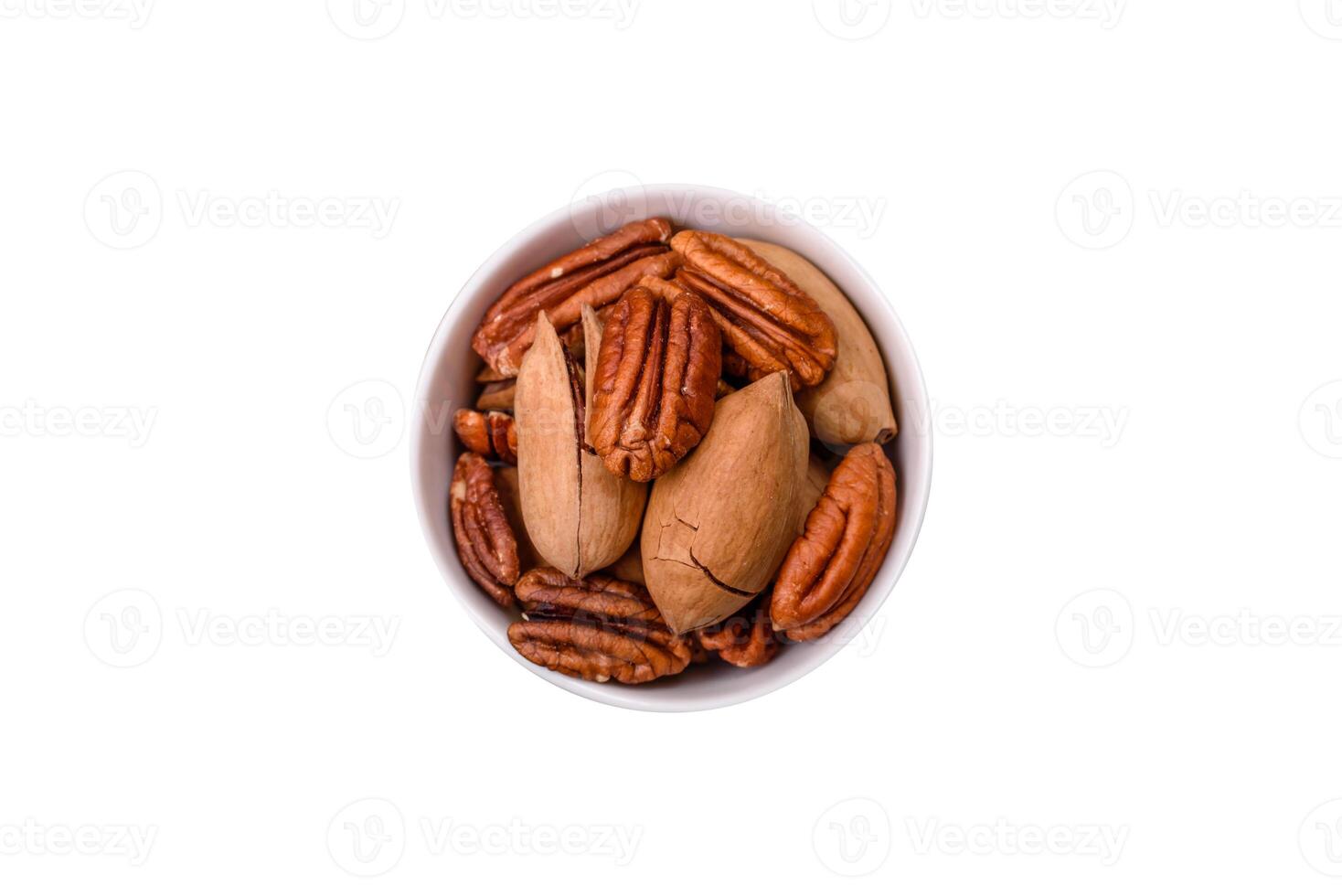 Delicious nutritious pecan nuts in ceramic bowl photo