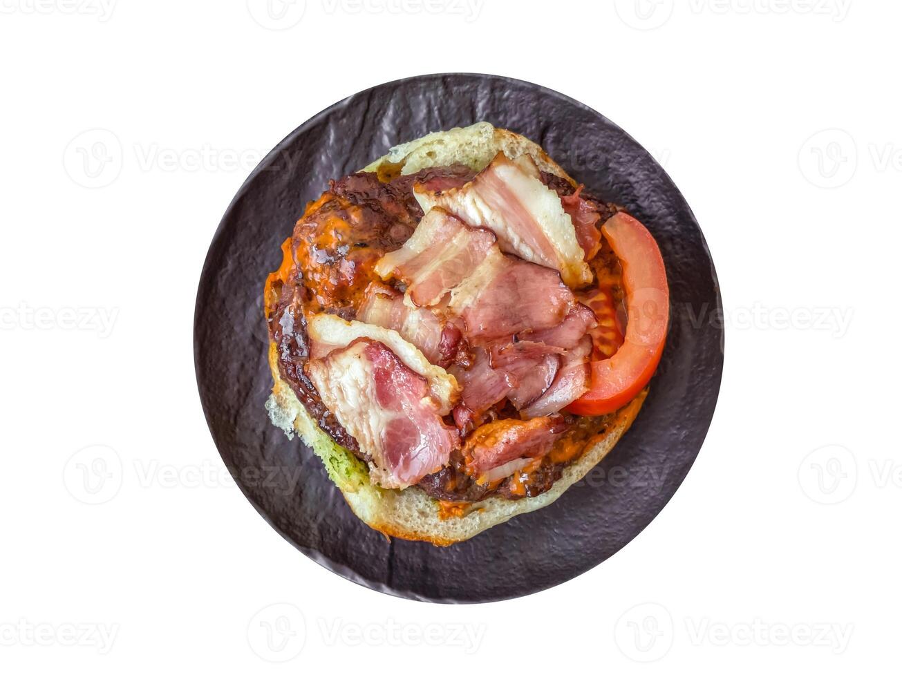 Juicy burger with beef patty, tomatoes, cheese, bacon, salt and spices photo