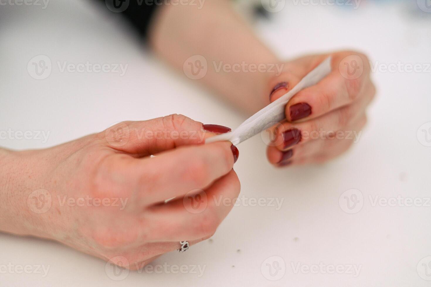 unrecognizable person prepare smoke hashish tobacco cigarette joint personal health relax use at home photo