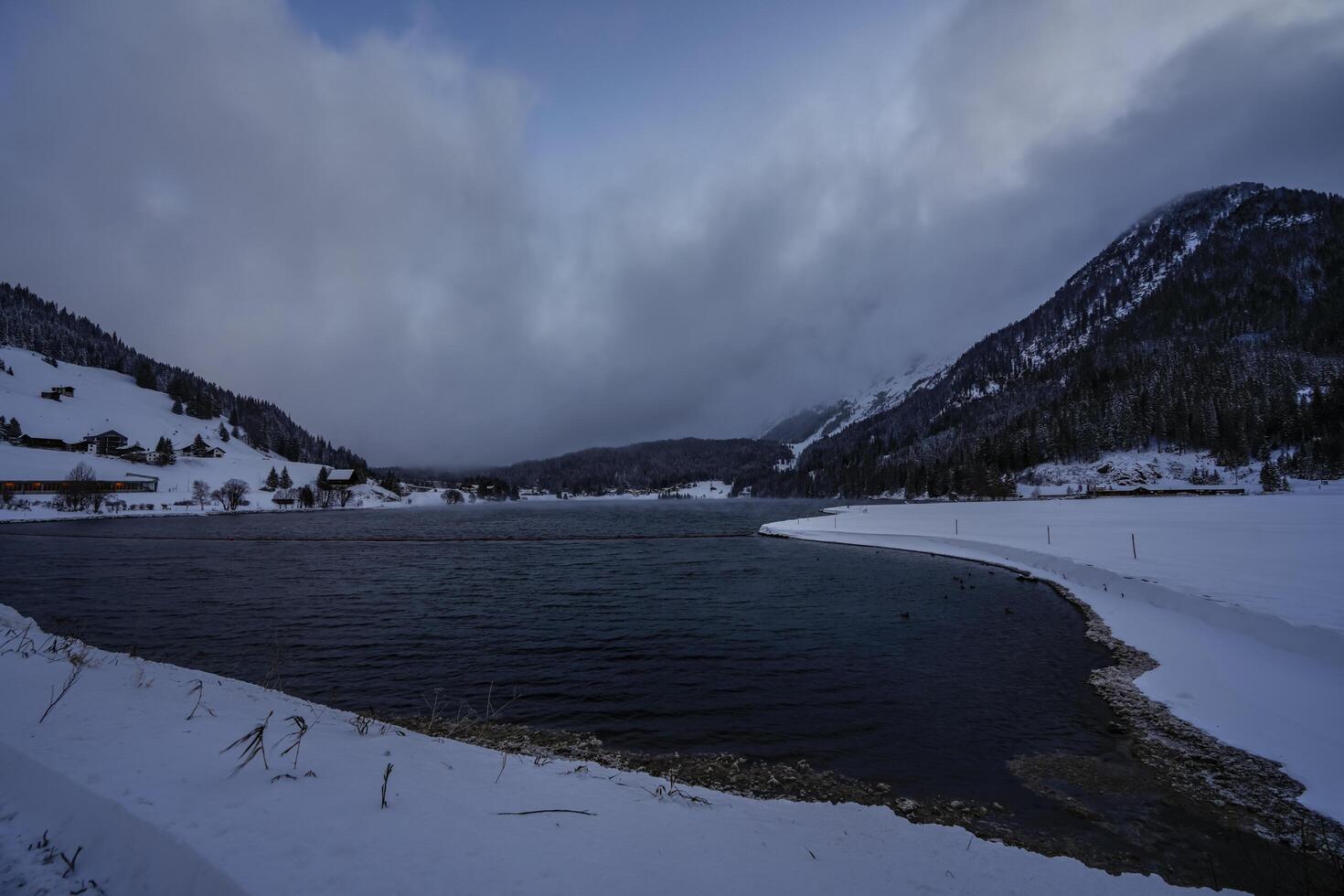 Winter scenery with view over a lake in the Swiss Alps, Grisons, Switzerland photo