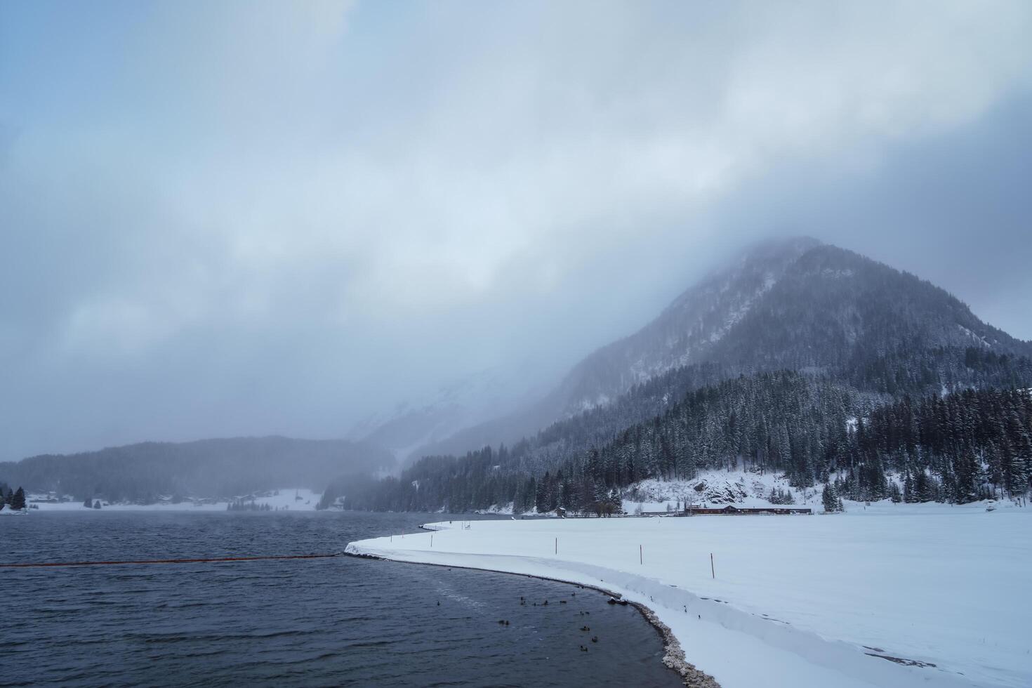 Fog over a lake in the Swiss Alps, Grisons, Switzerland photo